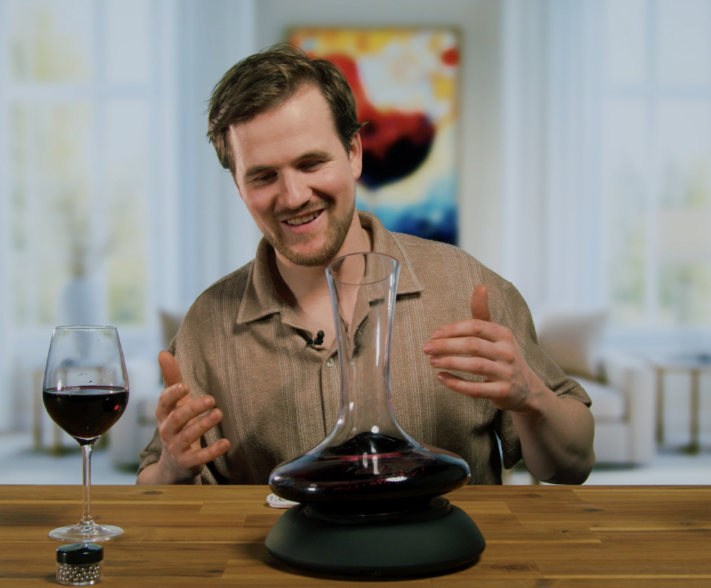 Man sitting behind an electric wine decanter
