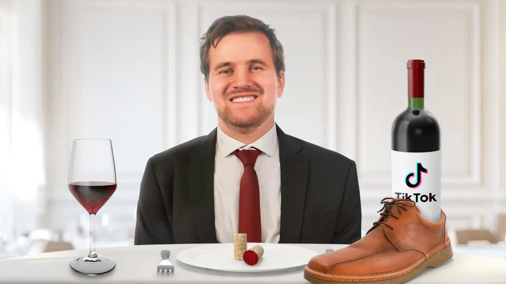 Video thumbnail of Daniel sitting at a table with a glass of wine and a bottle of wine inside of a shoe