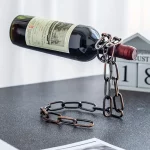 Iron chain wine bottle holder holding up a wine bottle